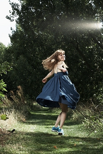 Sign up to mailing list Sophie twirling around in a blue dress